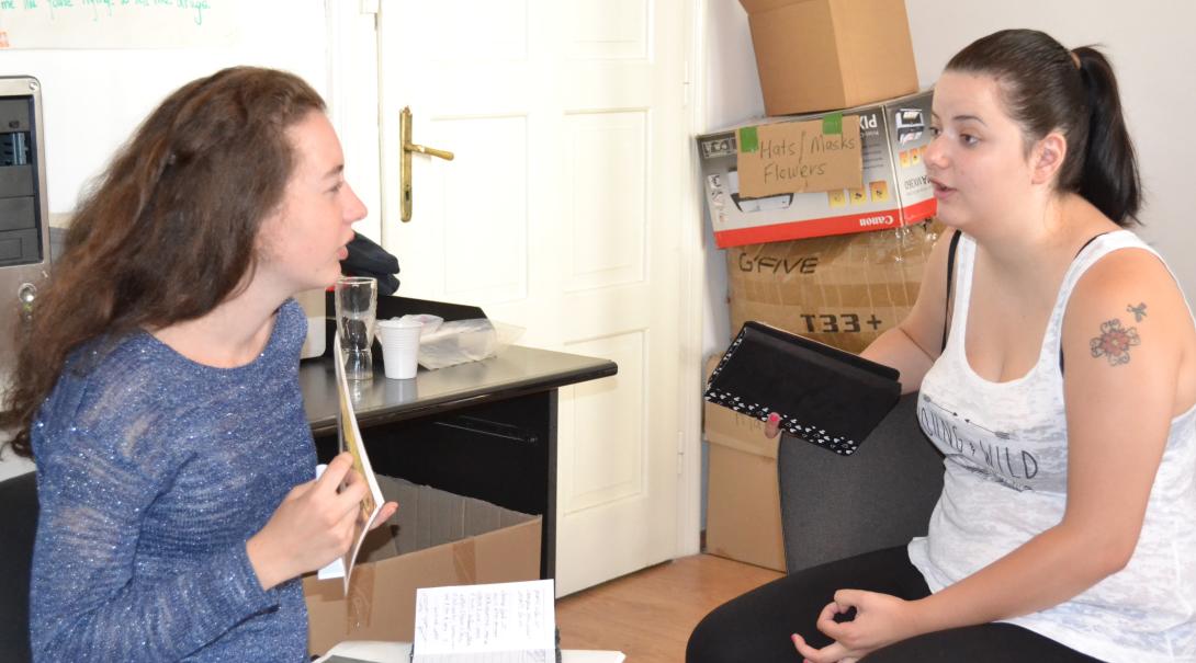 Teenage volunteer chat with each other about different interview techniques during their Journalism Project Journalism volunteers practice their interviewing skills as part of their project in Romania